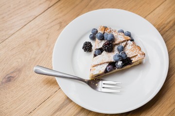 Tart with blackberries and blueberries on a plate