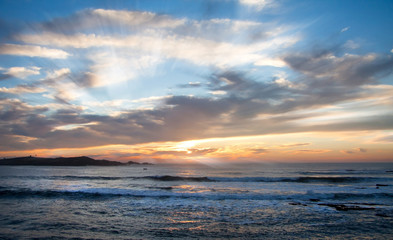 Obraz premium beautiful colorful sunset in ocean with stormy clouds and sun beams background. Morocco