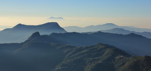 Early morning in the Annapurna Conservation Area, Nepal. View from Ghale Gaun. Hills covered by forest and valleys.