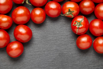 Cherry tomatoes over stone table.