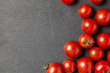 Cherry tomatoes over stone table.