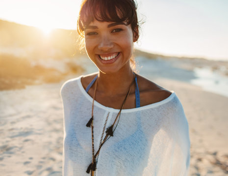 Portrait of young smiling woman on beach