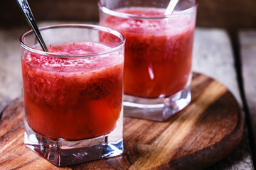 Strawberry jelly in glasses, vintage wooden background, selective focus