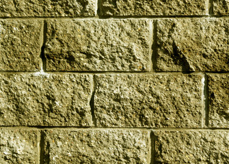 Yellow color stylized brick wall pattern.