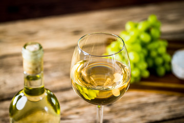 Wine bottles with grapes and cheese  on wooden rustic background. copy space