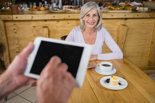 Hands of waiter using digital tablet