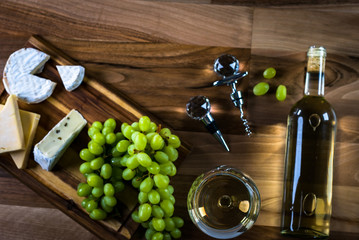 Obraz premium Wine bottles with grapes and cheese on wooden rustic background. copy space
