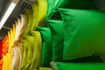 many colorful pillows on shelves