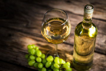  Wine bottles with grapes and cheese on wooden rustic background. copy space