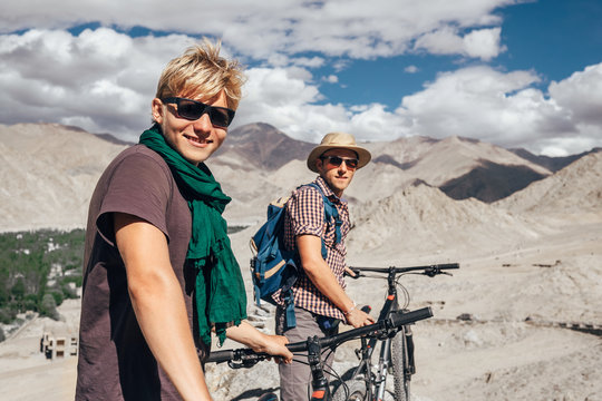 Two happy smiling mountain bikers in Himalaya mountain