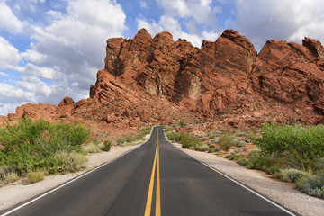 Desert Highway with Yellow Lines on Sunny Day