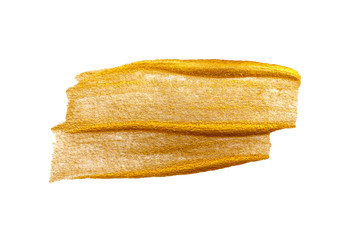 Abstract brush strokes with gold paint on paper