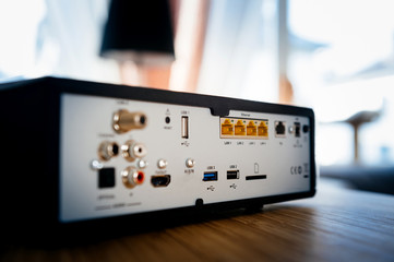 Rear view of a coaxial fiber internet modem with multiple lan ports, antenna in, usb, hdmi and optical digital audio port 