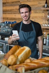 Waiter holding a mobile phone