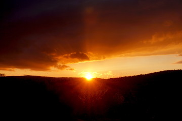 sunset landscape small mountain with clouds in the sky red