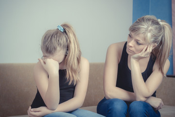 Teenager problems - Sad crying teenage girl and her worried mother