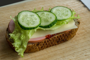 Delicious fresh sandwich on a wooden board