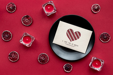 Ripe fresh fruit with love letter on red background top view