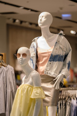 Woman mannequins in modern style outfit in clothes store