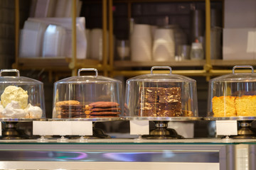 Sweet desserts on shopping window in small cafe