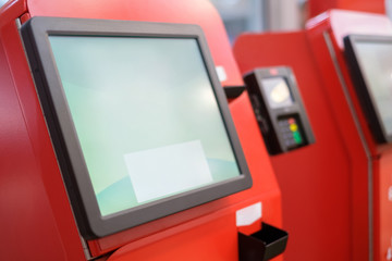 Self service cash desk with screen and card payment terminal in red in modern supermarket