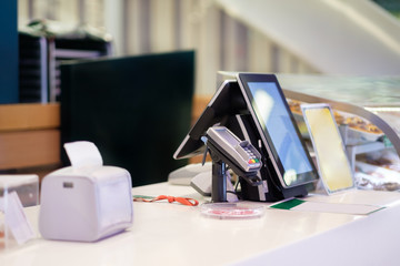 Cash desk with order screen and card payment terminal in small cafe