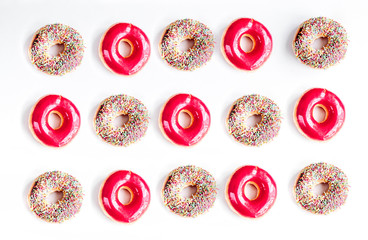 sweet colorful donuts with topping on white desk background top view pattern