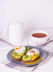 Toast with poached egg, puree avocado, spices and arugula