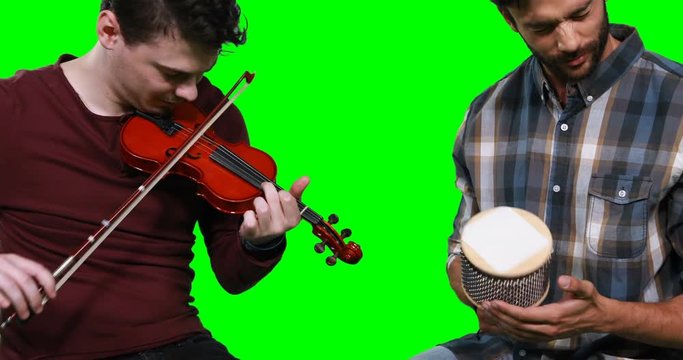 Male musicians playing violin and cabasa