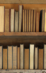 old books on wooden shelf.