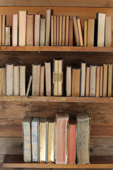 old books on wooden shelf.