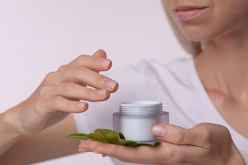 Woman holding organic moisturizing facial cream close up. Beauty, skin care concept