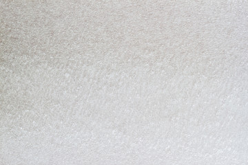 Texture of thermal insulating styrofoam close-up. Structure polystyrene plastic, light grey color. For background, design with copy space text or image