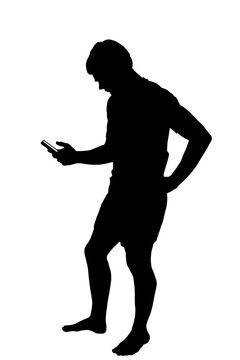 Full length side profile portrait silhouette of teenage boy texting on smart phone