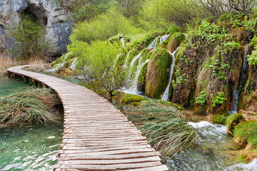 Winding wooden pathway and waterfalls in Plitvice National Park, Croatia