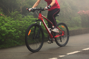 Fototapeta na wymiar cyclist riding mountain bike on foggy forest trail