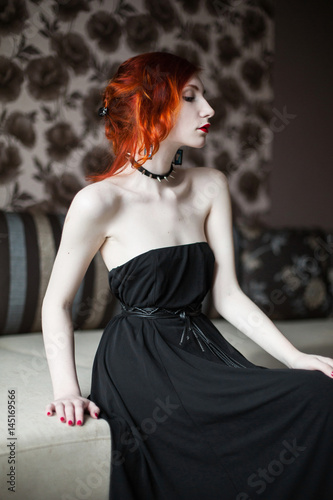 A Woman With Red Curly Hair In A Black Dress And Stockings Red