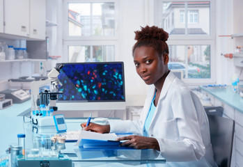 Female African scientist works in modern biological laboratory