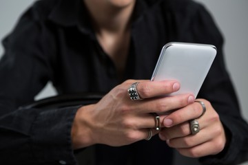 Androgynous person using mobile phone
