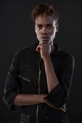 Androgynous man posing with hand on his chin