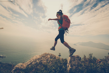 successful woman hiker hiking on mountain peak