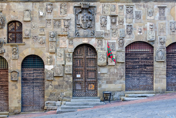 Coats of arms and heavy doors on the facade of Palazzo Pretorio - Arezzo, Italy
