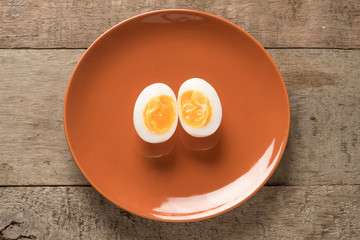 Medium-boiled egg, Top view. How many eggs a day concept.