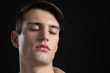 Obraz premium Androgynous man posing with his eyes closed