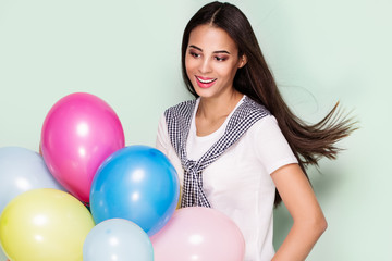 Fototapeta na wymiar Happy young woman with balloons.
