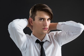 Androgynous man with hands on his neck