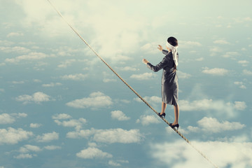 She is walking blindfolded . Mixed media