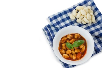 Overhead view of gnocchi pasta in bowl on napkin