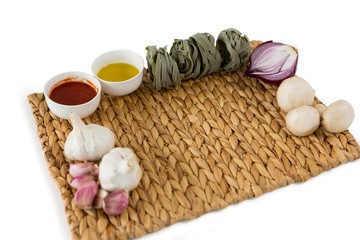 High angle view of vegetables with tagliatelle on place mat