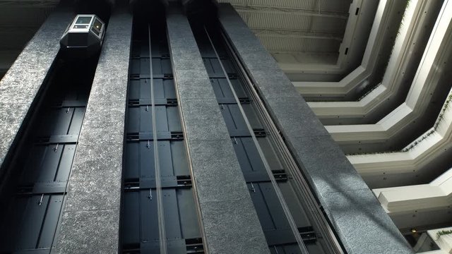 Luxury hotel building glass elevator lift moving down